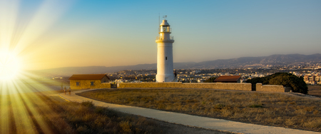 coast line with lighthouse, dune and rare vegetation in the background at sunset