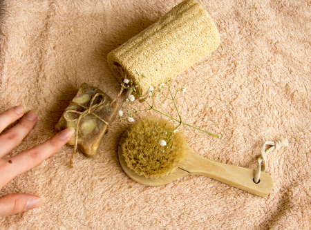 cosmetic concept with towel, brush, soap scrub, coffee beans, flowerの写真素材