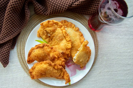 deep-fried golden chebureks are laid out on a plate
