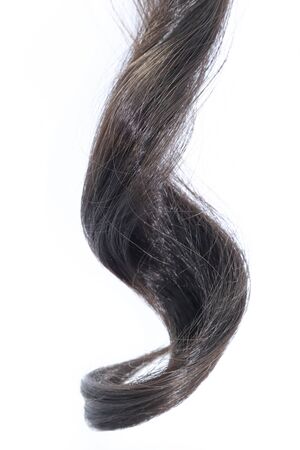 Piece of black hair on white isolated backgroundの写真素材