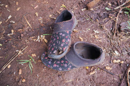 Old broken shoes with cracked soleの写真素材