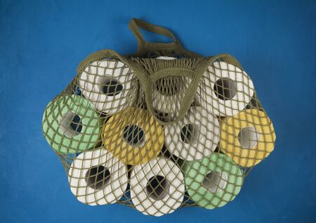 A string bag full with toilet paper.