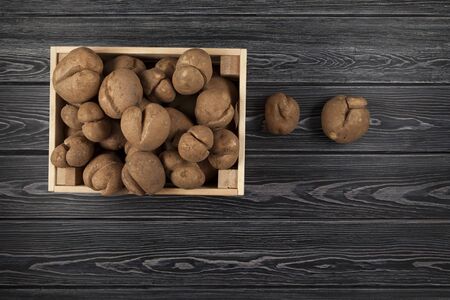 Wooden crate filled to the top with fresh raw ugly potatoes.  Top view. Copy space.の写真素材