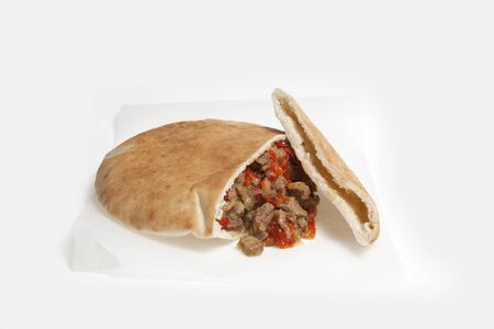 Pita or Arabic bread, stuffed with chicken and vegetables over light background. Closeup. Selective focus. Copy space.の写真素材