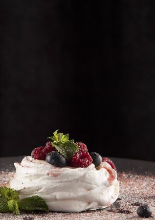 Meringue dessert with cream, berries and powdered sugar. Copy space.の写真素材