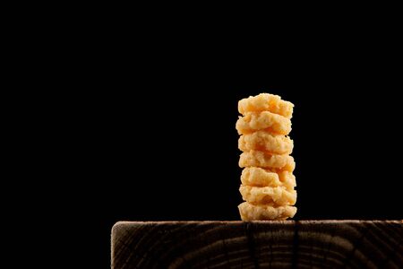 Crispy cheese chips against dark background, copy space. A healthy, low-carb snack.