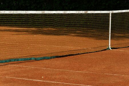 Fragment of an outdoor clay tennis court. Grid and marking lines visible, selective focus.の写真素材