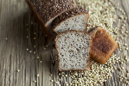 Bread made from organic green buckwheat with the addition of flaxseed. A loaf and sliced slices on...