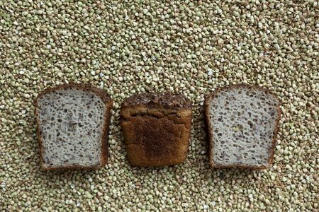 Three slices of bread made from organic green buckwheat with the addition of flaxseeds on the background of cereals.の写真素材