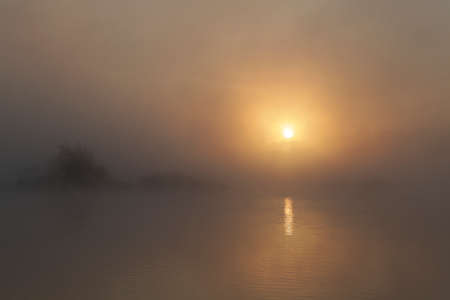 Early morning sunrise. Very dense fog over the river. Abstraction.の写真素材