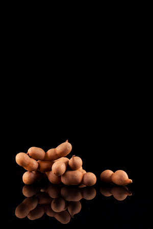 Tamarind (Tamarindus indica) is an edible fruit native to Tropical Africa. Used in cuisines around the world. The pulp is also used in traditional medicine. Selective focus, copy space.の写真素材