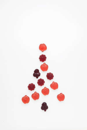 Chewy fruit marmalade with natural juice and pectin on a light background with copy space. Concept - Alternative Christmas tree.の写真素材