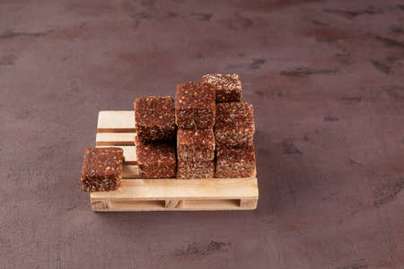 Healthy sweets. Dried fruit sweets (dried dates, prunes or apricots) with honey and nuts. Selective focus, copy space.の写真素材