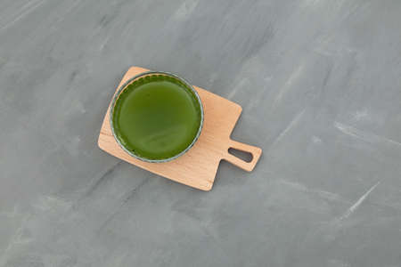 Glass with herbal drink of moringa leaves, top view. Healthy eating. Green leaves have medicinal properties.の写真素材