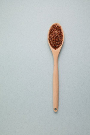 Brown rice. GABA rice in wooden spoon on light textured background. Top view, place for text.の写真素材