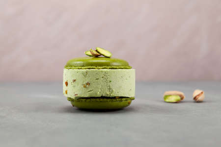 Delicious pistachio ice cream with pistachio macarons or macaroons, side view. Selective focus, copy...