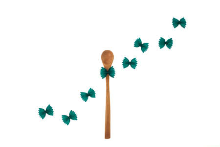 Farfalle with spirulina or chlorella. Green pasta products in form butterfly on white background. Trend - increase consumption of food with healthy food additives and natural organic dyes.の写真素材