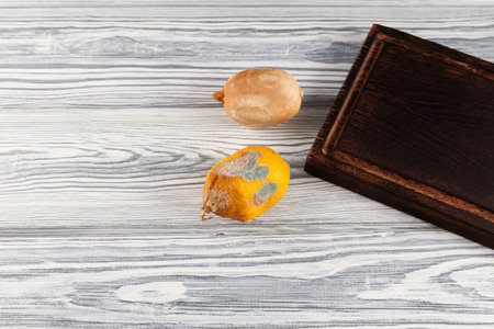 Two spoiled lemons with mold on light background. Selective focus, copy space.の写真素材