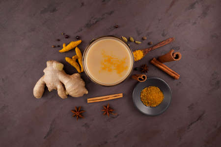 Popular traditional Indian / Asian drink Masala Chai or Spicy herb tea with all the ingredients on...