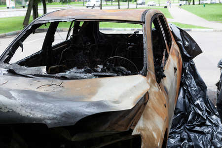 Completely burnt-out passenger car. Abandoned unattended transport. Selective focus.の写真素材