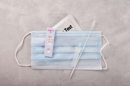 Rapid test for Covid-19 Coronavirus, positive result. Laboratory kit for self-testing at home.の写真素材