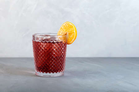 Americano Alcohol cocktail with red vermouth, bitter, soda water, orange zest and ice. Side view,...