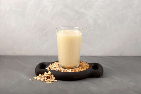 Oat milk - fresh organic and vegetarian non dairy alternative drink. Vegan oat milk in a tall glass.の写真素材