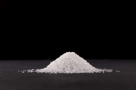 Glutamic acid monosodium salt on dark background. Msg. Food additive E621. Flavor seasoning for...