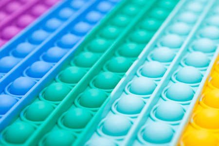 Abstract blurred color background on the theme of trendy POP IT toys. Design element. Silicone toy surface, perspective, defocused. Copy space.の写真素材