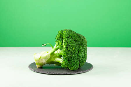 Broccoli cabbage on green background. Selective focus, copy space.の写真素材