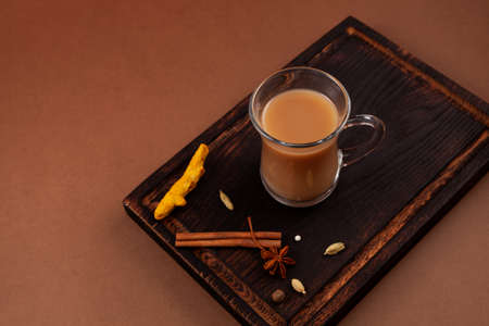 Karak tea or Masala chai, top view. Popular Indian warming drink. Prepared with milk, variety of spicy and spices.の写真素材