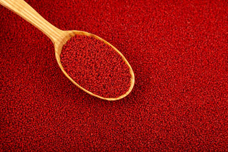 Beetroot couscous in wooden spoon, close-up. Selective focus, copy space.の写真素材