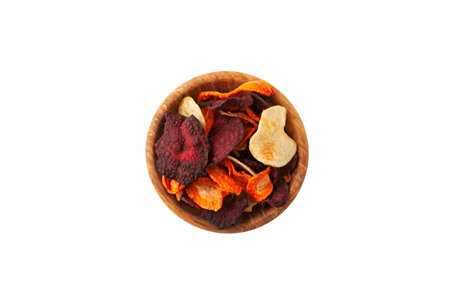 Vegetable chips (Beet, Potato, Carrot) or Dried veggies slices. Dehydrated vegetables in wooden bowl on white background, top view. Healthy vegan snacks.の写真素材