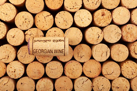 Moscow, Russia, June 06, 2022 | One wine cork with stamping GEORGIAN WINE lies on used cork...