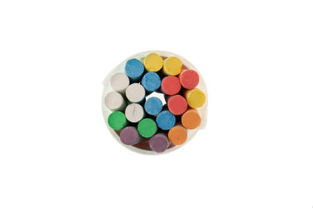 Chalks in plastic box on white background, top view. Colored crayons for drawing on asphalt or...