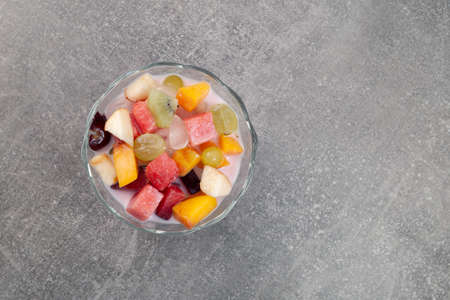 Es Buah or Es Campur on gray background, top view. Popular indonesian fruits cocktail dessert. Fruit...