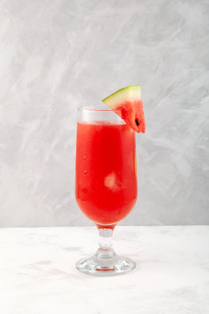 Watermelon smoothie or watermelon iced punch. Refreshing summer drink on gray background. selective focus.の写真素材