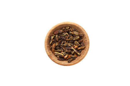 Dried fruits of Sophora japonica in wooden bowl isolated on white background. herbal therapy. Fruits and seeds are used in alternative medicine, contain rutin, fatty oils, linoleic acid.の写真素材