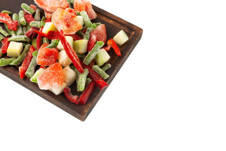 Different Frozen Vegetables, tomatoes, string beans, zucchini, red pepper on wooden cutting board, close-up. Concept - Freezing and proper defrosting of vegetables. Design element, copy space.の写真素材