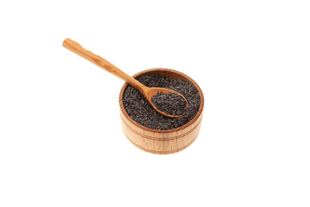 Blue poppy seeds in wooden bowl isolated on white background. Selective focus, copy space. design element. Delicious Food ingredient, used in culinary.の写真素材