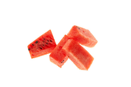 Watermelon pieces on white background, close-up, selective focus. Sugary watermelon pulp cubes with seeds.の写真素材
