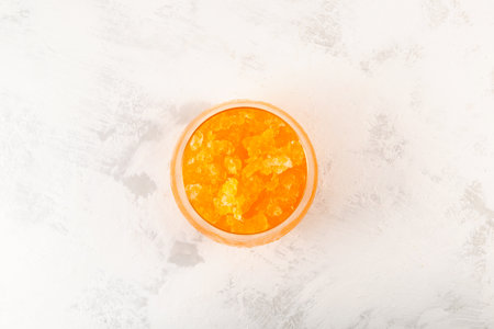 Glass of iced Orange Juice, Top view. Orange Granizado. Refreshing Slushie drink. Iced fruit drink. Sweet citrus Shaved ice.の写真素材