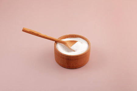 Stevioside powder, glycoside derived from the stevia plant, natural sweetener. Extract found in the leaves of Stevia rebaudiana. Food additive E960. Sugar substitute in wooden bowl.の写真素材