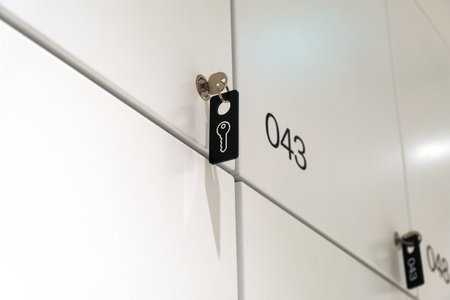 Closed metal locker with a key and key tag in the office. Individual confidential locker, luggage...