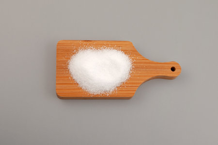 Sugar substitute Xylitol, Xylit powder or birch sugar on wooden board. Food additive E967, sweetener, moisture-retaining agent, stabilizer and emulsifier. Xylitol has 2.4 kilocalories per gram.の写真素材