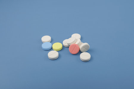 traditional medicine. Classic round tablets on blue background, selective focus. design element. Increased consumption of medications, antidepressants and sedative pills.の写真素材