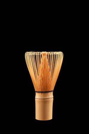 Chasen or Bamboo tea whisk on black background, close-up. Accessory for whipping Matcha tea.の写真素材