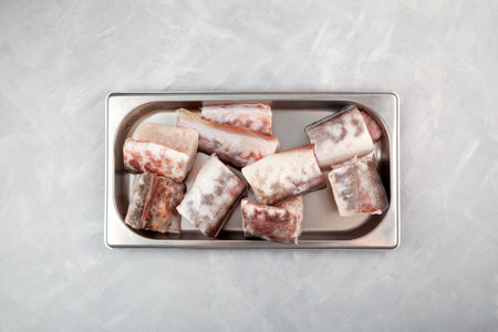 Pieces of raw fish sea eel on metal tray. Congrio, shrimp fish or sea pink eel. Genypterus blacodes, Ophididae family.の写真素材