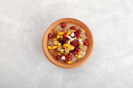 Ashure Dessert in clay bowl, top view. Turkish pudding also called as Noah's pudding or Noah's Dessert. Sweet porridge, which consists of grains, fruits, dried fruits and nuts.の写真素材