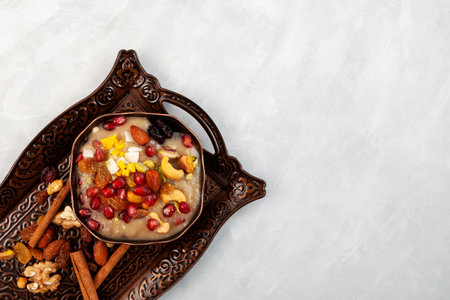 Ashure or Asura Dessert, also called as Anusabur on metal serving tray. Sweet pudding also called as Noah's pudding or Noah's Dessert. Turkish delicious porridge with grains, fruits, and nuts.の写真素材